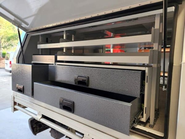Truck bed with storage drawers and shelves