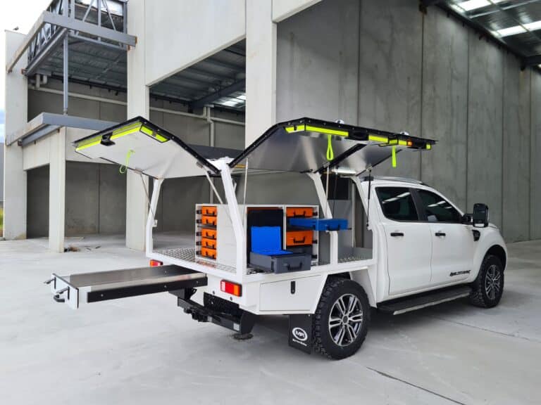 RolaCase White pickup truck with an open cargo bed in a warehouse setting
