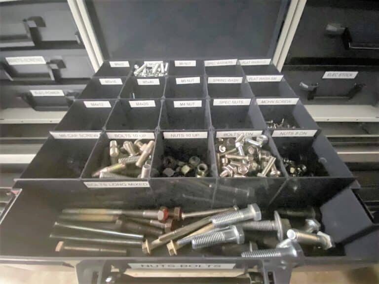 Organized storage system with labeled drawers containing various hardware items.